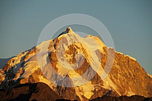 Snow covered mountain at sunset light