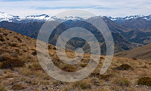 Snow covered mountains as seen from the top of the Ben Lomond Peak near Queenstown, New Zealand photo