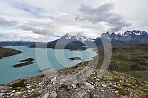 Snow covered mountains with the light blue ocean in front in Torres del Paine National Park in Chile, Patagonia