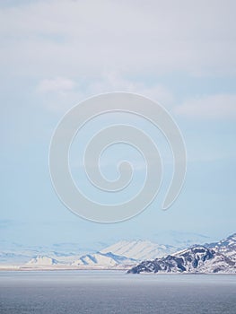 snow-covered mountains in distance and coldness sea