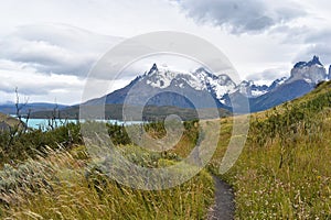 Snow covered mountains with the light blue ocean in front in Torres del Paine National Park in Chile, Patagonia