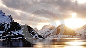 Snow covered mountains at Sundstraumen on the Lofoten in winter in Norway at sunset