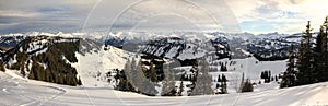 Snow covered mountains and trees. Amazing Panoramic snowy winter landscape in Alps at sunrise morning. Grasgehren Ski