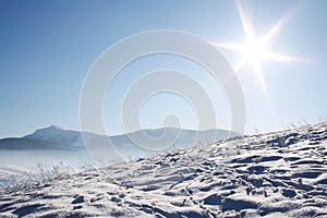 Snow covered mountains under blue sky