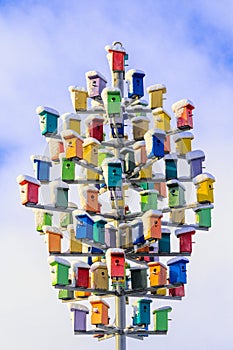 Snow-covered nesting boxes against the sky.