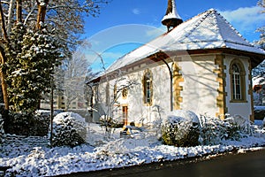 Snow covered old protestant church in Lyss, Switzerland