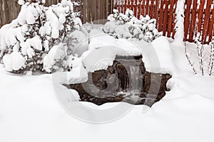 Snow covered outdoor water feature