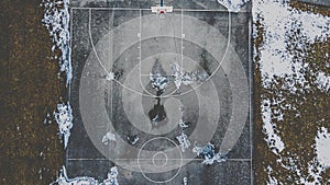 Snow covered park with basketball court