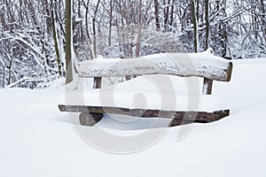 Snow covered park bench