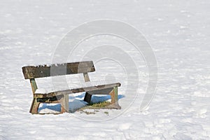 Snow covered park bench