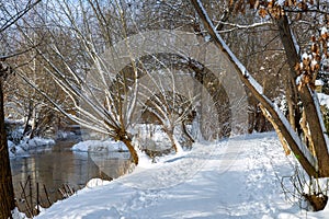 Snow-covered path over the stream