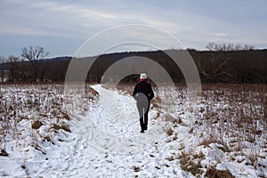 Snow covered path with woman walking