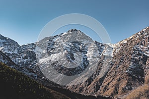 Snow covered peak of mount Toubkal in Morocco during spring on a sunny day. Atlas mountain range near Marrakesh. Start