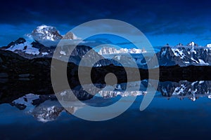 Snow-covered peaks of French Alps mirroring in Cheserys lakes