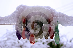 Snow covered pegs on a snow covered back drop