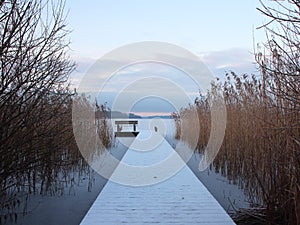 Snow covered Pier at Lake with Reed