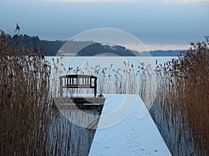 Snow covered Pier at Lake with Reed