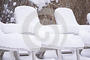 Snow covered pool deck chairs