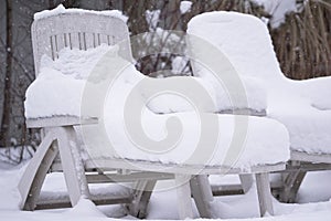 Snow covered pool deck chairs