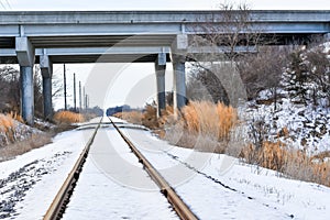 Snow Covered Railroad Tracks with Bridge