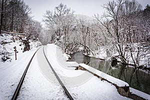 Snow covered railroad tracks and a creek in rural Carroll County photo