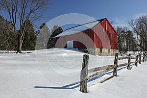 Snow Covered Red Barn and Split Rail Fence