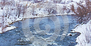 Snow-covered river bank in winter
