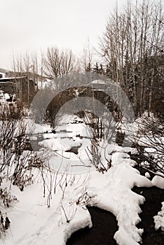 A snow covered river in Vail, Colorado during winter.