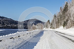 Snow-covered road along the Biya River. Russia,