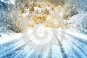 Snow covered road in mountains on snowy day