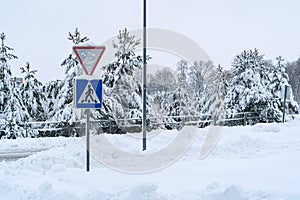 Snow covered road pedestrian sign