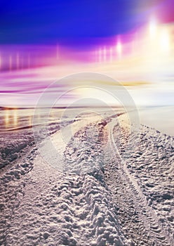 Snow covered road and polar lights