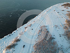 Snow covered road on a steep seashore in Paldiski, winter day, photo from a drone