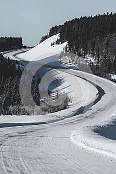 A snow covered road winding up a mountain