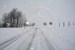 Snow-covered road in winter in the countryside