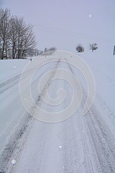 Snow-covered road in winter with nature