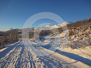 A snow covered road in winter wonderland in Tuddal, Norway