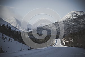 Snow-covered roads through snow-covered mountains