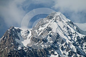 Snow covered rocky high mountain