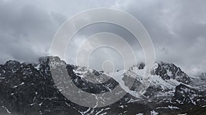 Snow-covered and rocky mountains of the Zailiyskiy Alatau.