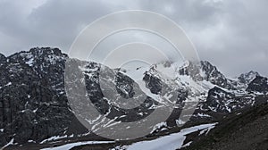 Snow-covered and rocky mountains of the Zailiyskiy Alatau.