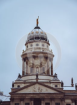Snow covered roof of New Church also called Deutscher Dom or German Cathedral and French Catheral on Gendarmenmarkt in