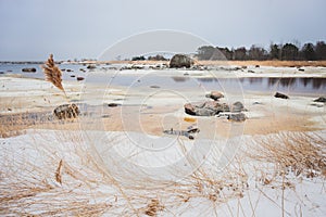 Snow covered seashore on cold spring morning