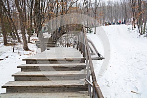 Snow covered stairs near the ice slope.