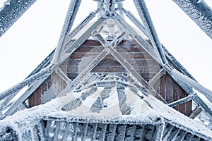 A snow-covered steel lookout tower on top of the Klodzka Mountain
