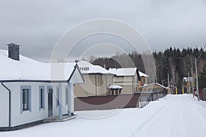 Snow covered street in a country village, new house, winter, Moscow region, December 2021