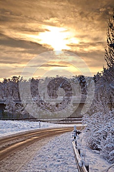 Snow covered street in sunrise in winter