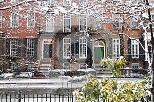 Snow covered streets and sidewalks along Washington Square Park during a winter storm in New York City