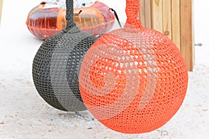 A snow-covered swing in the modern style in the form of big balls.