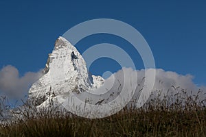 Snow covered top of Matterhorn mountain in deep blue sky with me